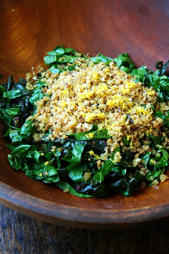 A bowl of lemon zest, breadcrumbs, and chopped chard.
