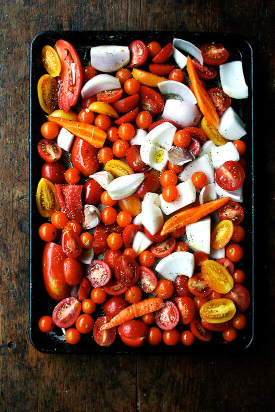 A sheet pan loaded with chopped vegetables.