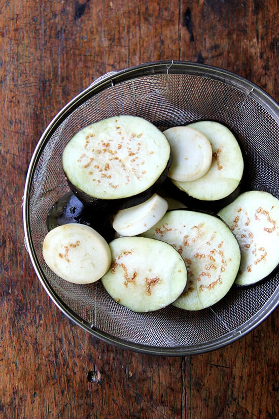 salted eggplant draining in a colander 