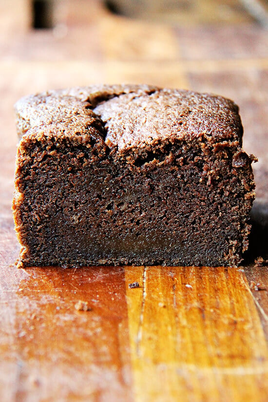 A halved loaf of Nigella Lawson's dense chocolate loaf cake. 