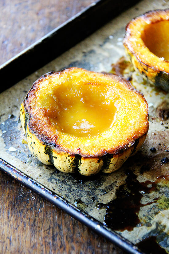 A sheet pan with roasted acorn squash. 