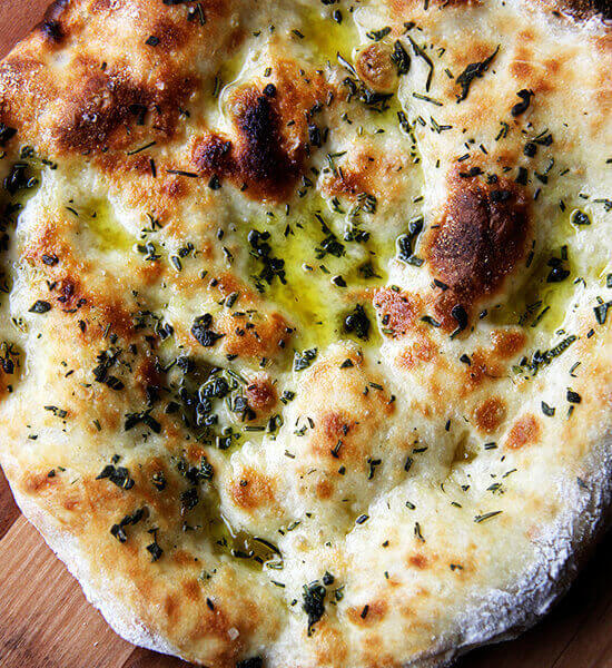 Herbed flatbread on a peel.