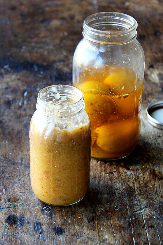 A jar of preserved lemon purée and preserved lemons.