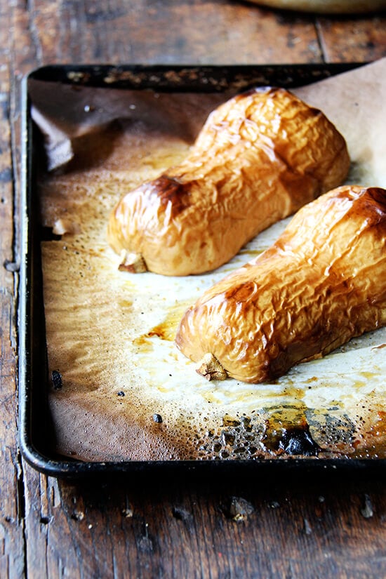 A roasted butternut squash on a sheet pan. 