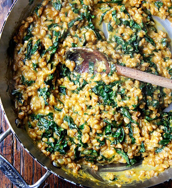 A pan of farro risotto with roasted butternut squash and kale.
