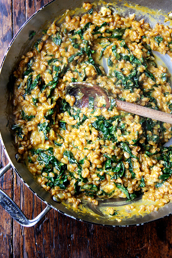 A pan of farro risotto with roasted butternut squash and kale.