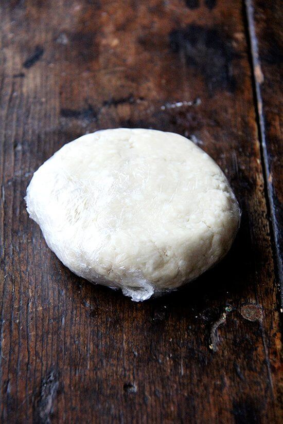 A round of pie dough on a table. 