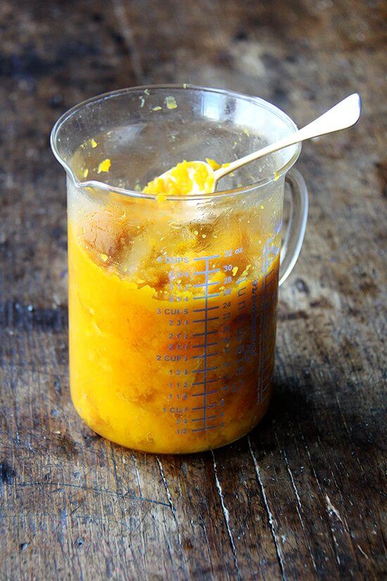 Roasted butternut squash purée in a liquid measuring cup. 