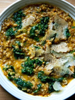 A bowl of farro risotto with butternut squash and kale.