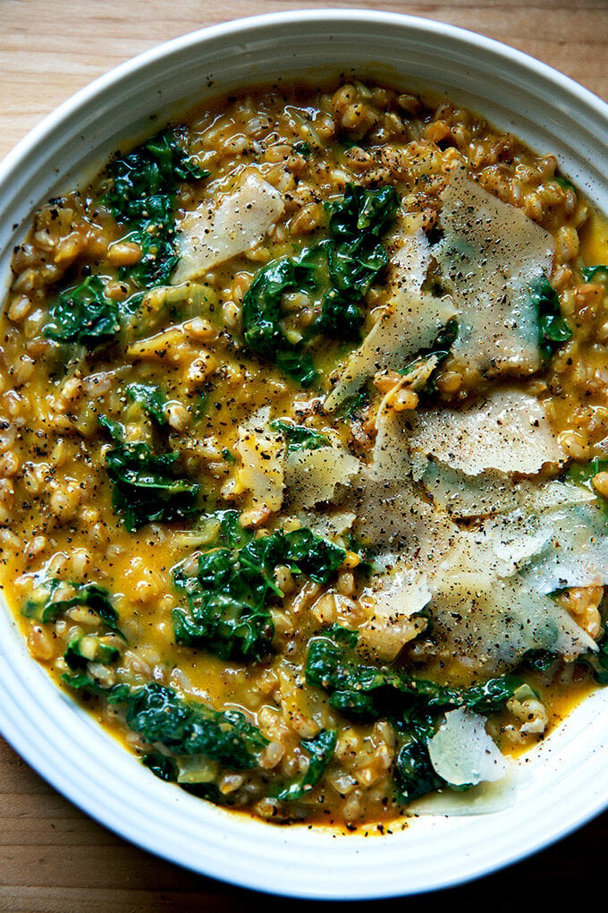 A bowl of farro risotto with butternut squash and kale.