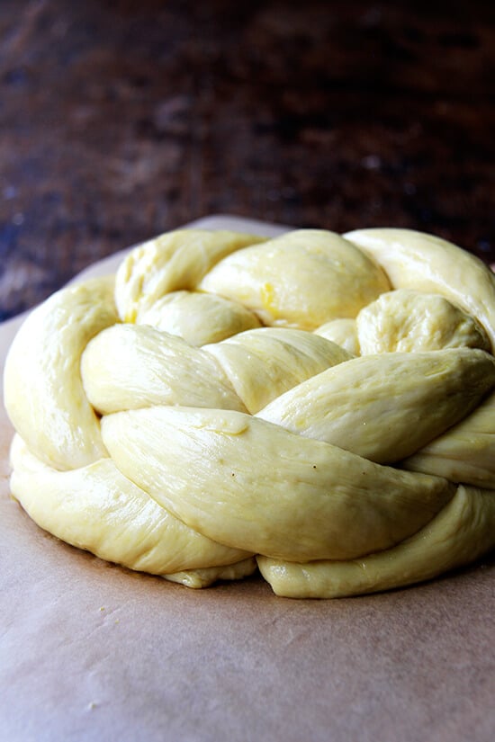 An egg washed round challah bread and ready for the oven.