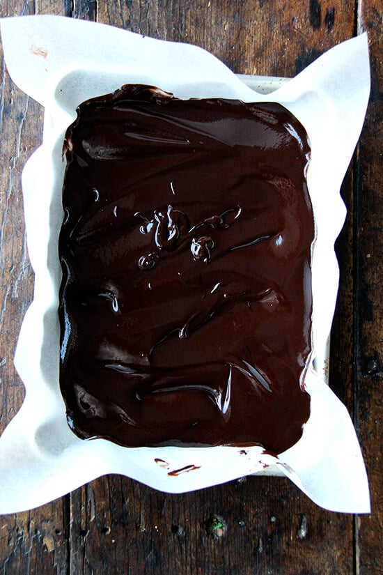 Truffle batter spread into a parchment lined baking dish.