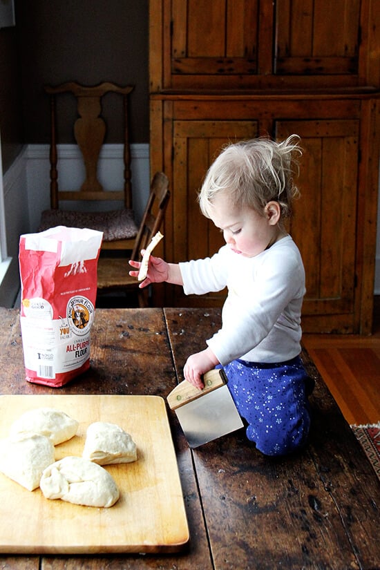 Wren, on the table, helping with the challah bread dough. 