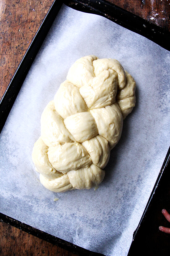A braided challah bread, ready for oven.