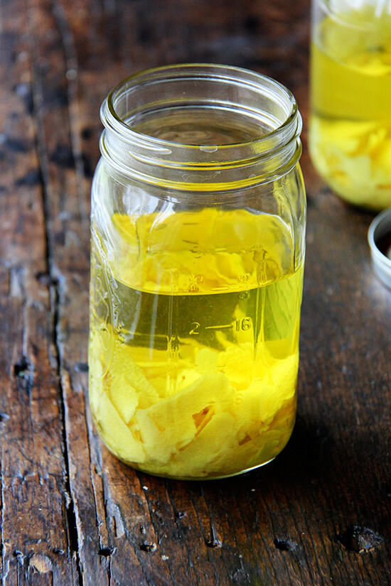 A large Mason jar filled with lemon zest and Everclear grain alcohol. 
