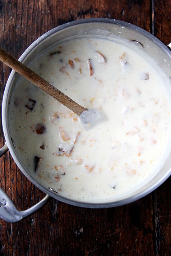 A bechamel sauce in a saucepan with roasted butternut squash. 