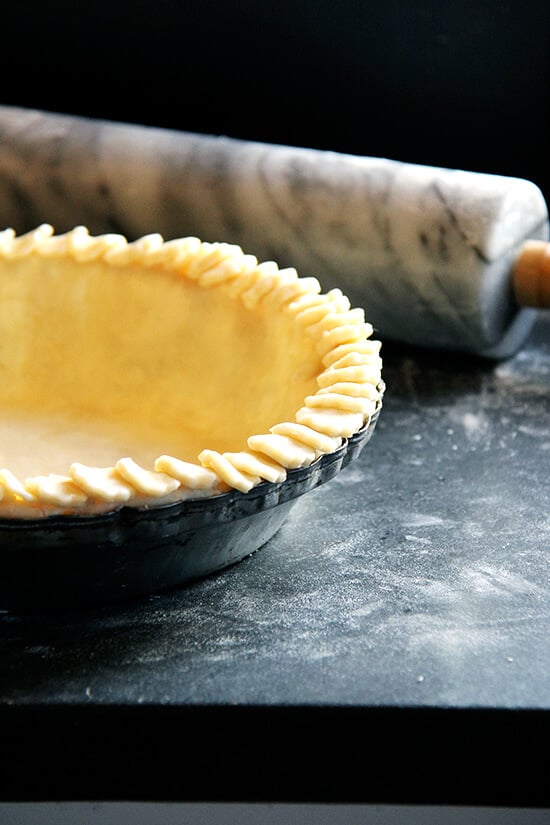 An unbaked pie with a decorative rim.