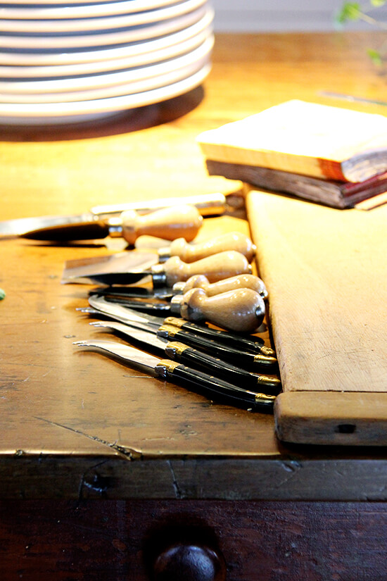 Cheese knives on a table. 