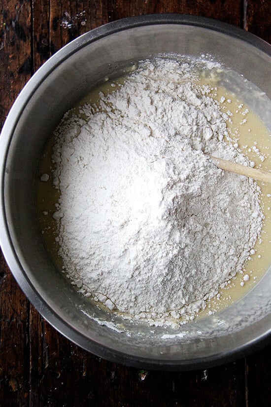 adding the flour to the sponge for the challah bread dough