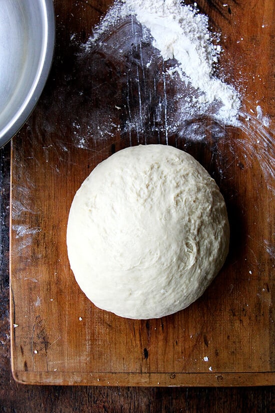 kneaded challah bread dough on a board