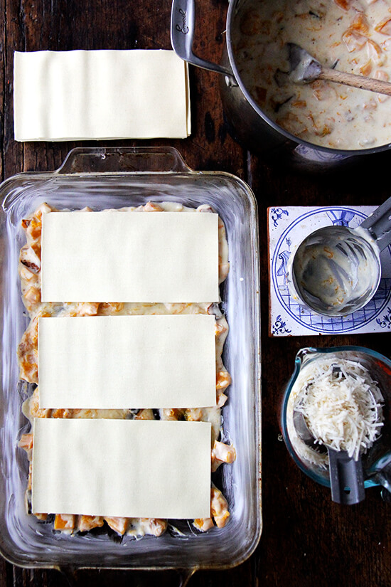A 9x13-inch pan with a layer of bechamel and 3 dried lasagna sheets. 