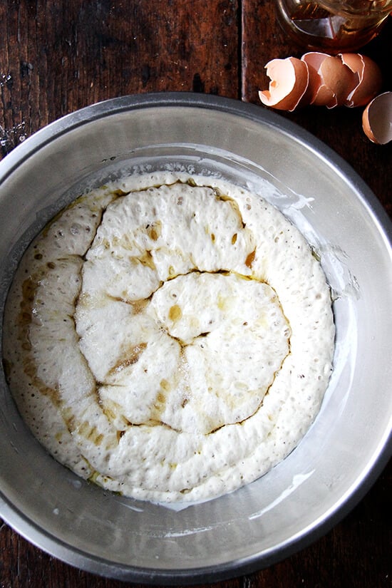 adding the honey and eggs to the sponge for the challah bread dough