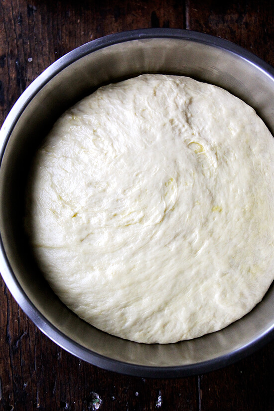 A bowl of challah bread dough, risen.