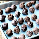 Boozy chocolate truffles on a sheet pan.