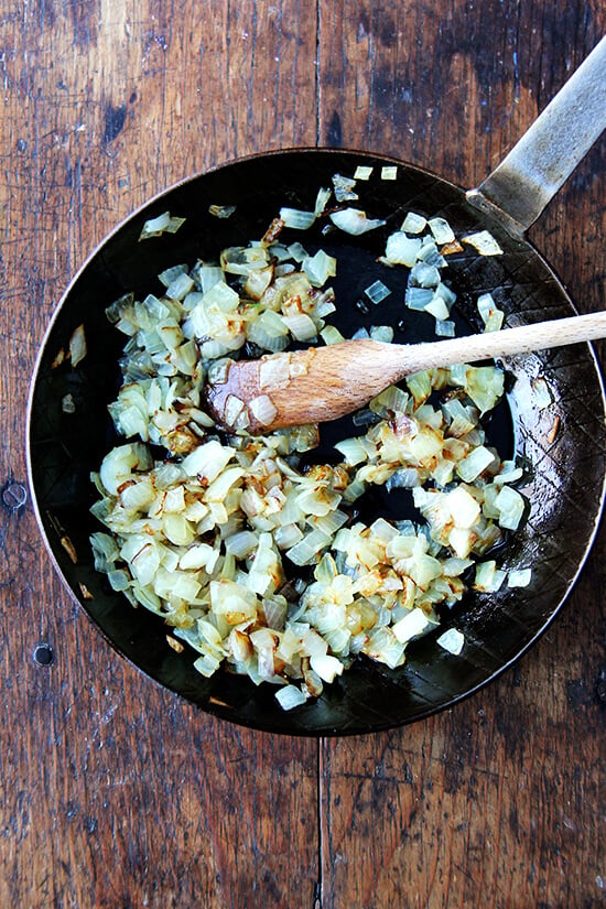 A skillet holding sautéed onions.