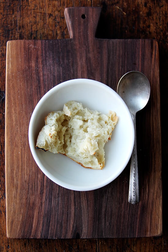 A bowl with a hunk of bread in it. 