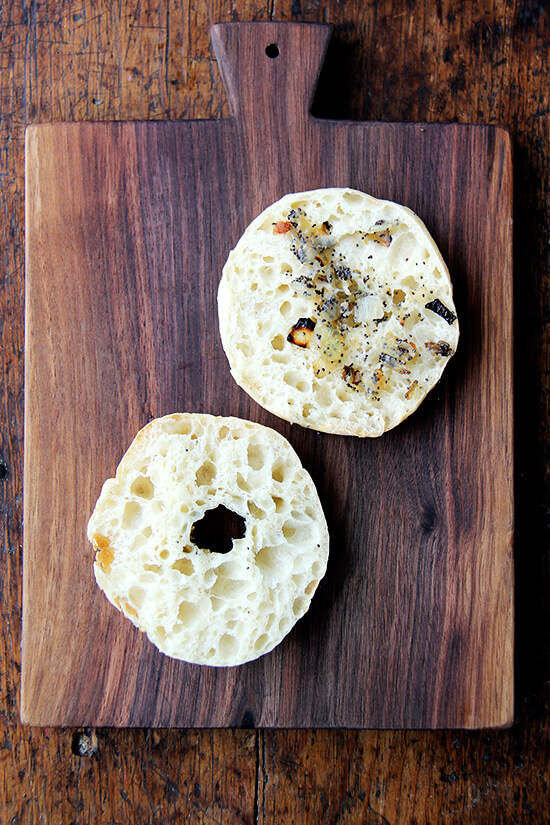 A halved bialy on a board.