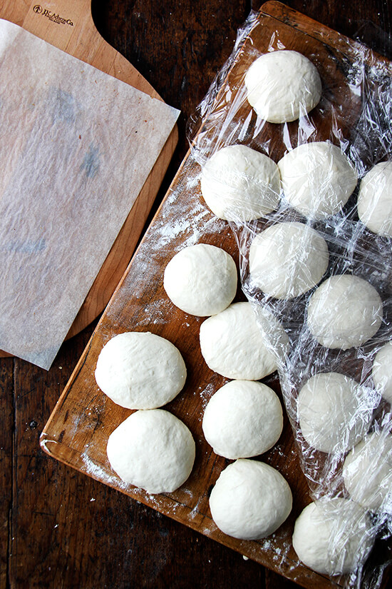 Bialy dough balls rising on a board.