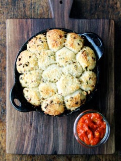 This garlic and thyme monkey bread with spicy tomato sauce would nicely complement any pasta dish (for all of you carb lovers that is) but would also be wildly received at any sort of Super Bowl gathering. // alexandracooks.com