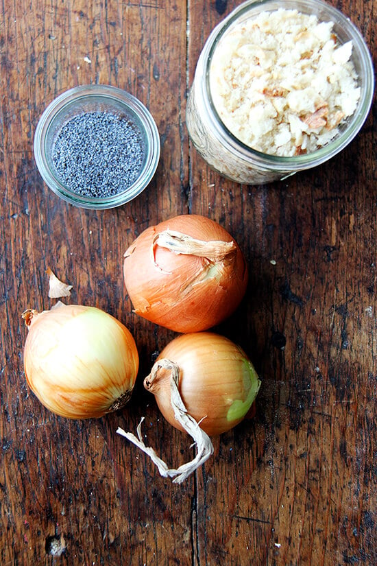 The ingredients to make the bialy filling on a table: poppyseeds, onions, and bread crumbs. 