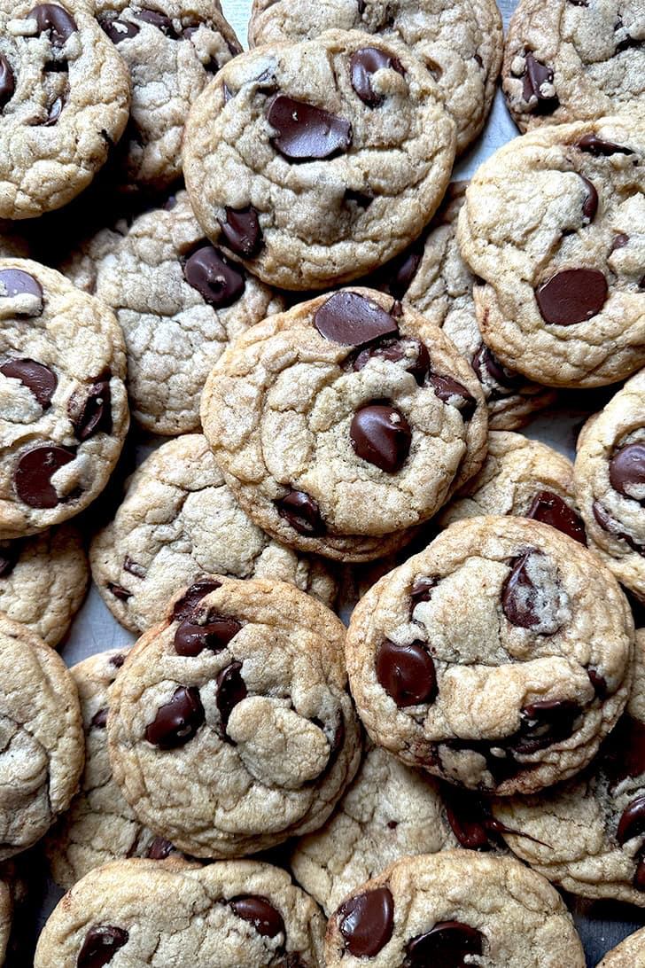 A tray of soft and chewy chocolate chip cookies made with melted butter.