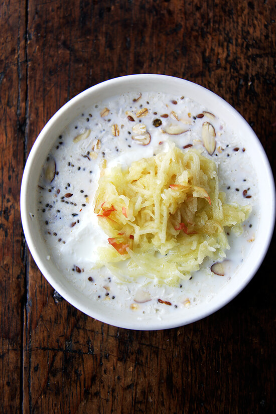 A bowl of Bircher muesli topped with grated apple. 