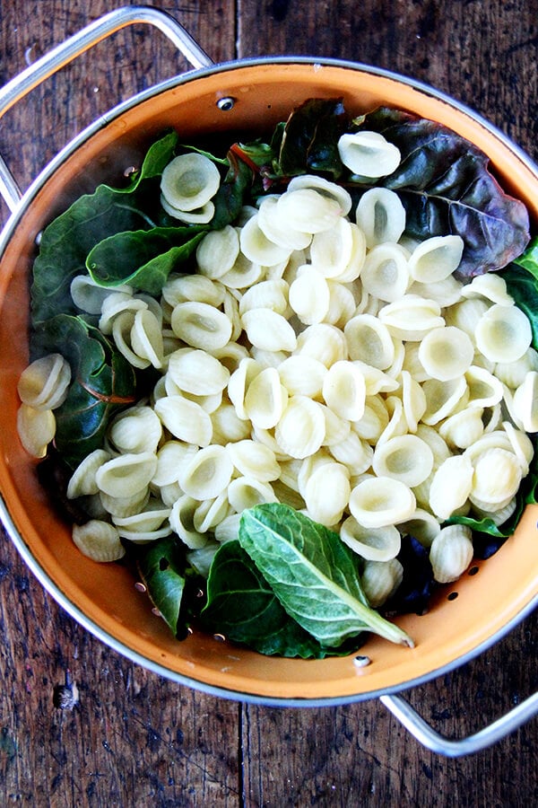 orecchiette and greens in a colander