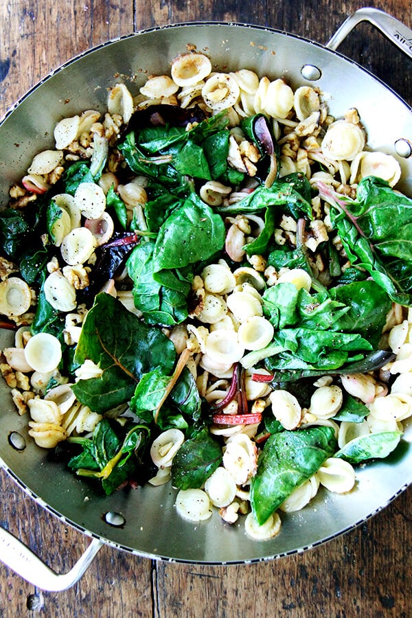 pasta and chard in pan with brown butter and walnuts