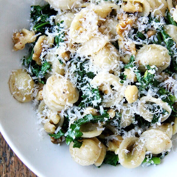 A bowl of pasta with swiss chard, brown butter, and walnuts.