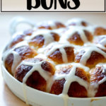 Hot cross buns, freshly glazed with icing.