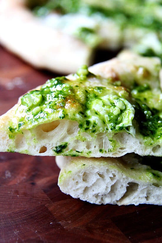 In this pesto pizza, while the pizza isn't baked completely naked, the process is similar: scatter cheese lightly across dough, drizzle it with olive oil and bake it until bubbling. Immediately upon pulling it from the oven, brush it with a thinned-out ramp pesto and a sprinkling of sea salt. Withholding the pesto from the pizza until it's out of the oven preserves not only its sharp, punchy flavor but also its vibrant green color. // alexandracooks.com