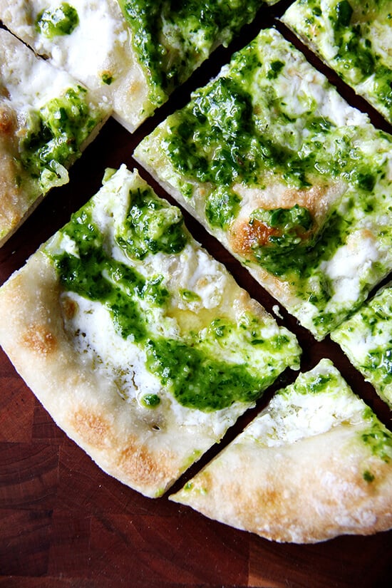 In this pesto pizza, while the pizza isn't baked completely naked, the process is similar: scatter cheese lightly across dough, drizzle it with olive oil and bake it until bubbling. Immediately upon pulling it from the oven, brush it with a thinned-out ramp pesto and a sprinkling of sea salt. Withholding the pesto from the pizza until it's out of the oven preserves not only its sharp, punchy flavor but also its vibrant green color. // alexandracooks.com