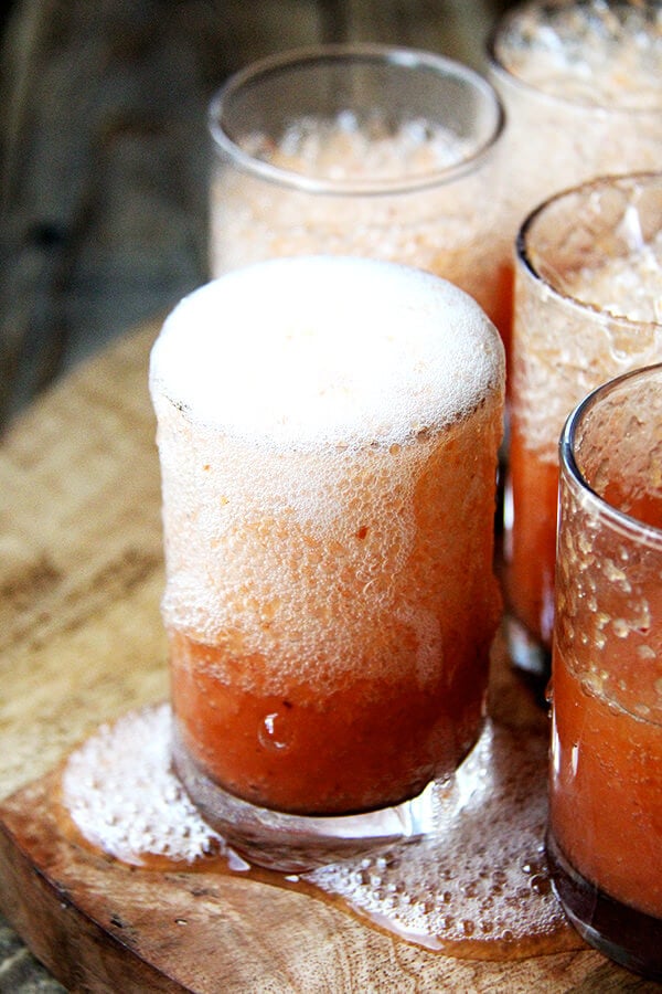 This peach bellini recipe is made by throwing whole peaches, skins and all, into the blender. It is a breeze to throw together and tastes light, summery and refreshing — maybe something festive to consider this weekend? // alexandracooks.com
