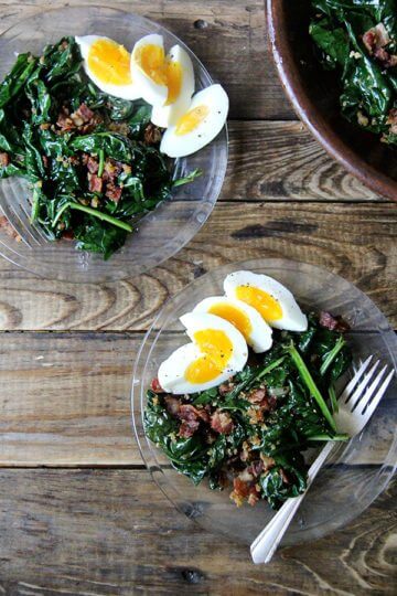 Warm spinach salad on a plate.