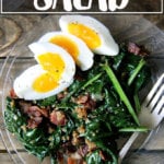 A plate of warm spinach salad with bacon and bread crumbs.