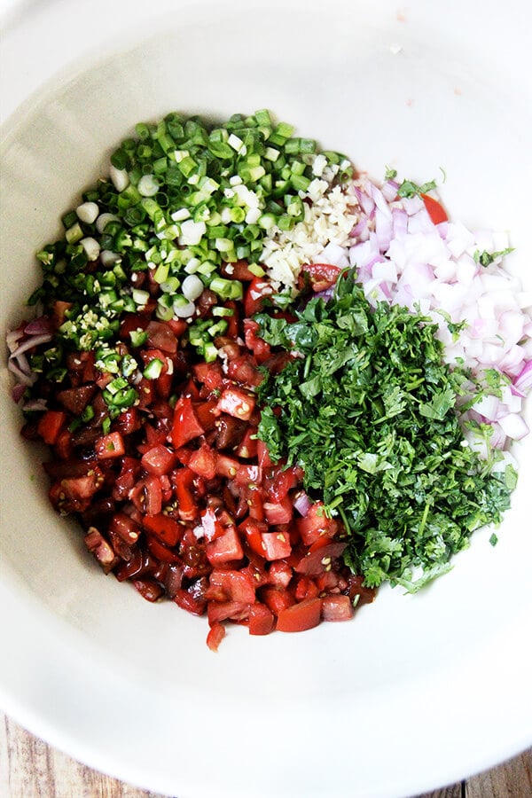 Tomato salsa ingredients in a large bowl. 