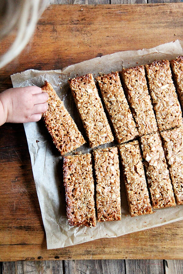 In these granola bars, I use oats, coconut, almonds and millet for the dry ingredients, the same makeup as the granola. For the glue, I use coconut oil or butter, maple syrup, brown rice syrup and almond butter. They hold their shape at room temperature and have thus become a lunch box staple. // alexandracooks.com