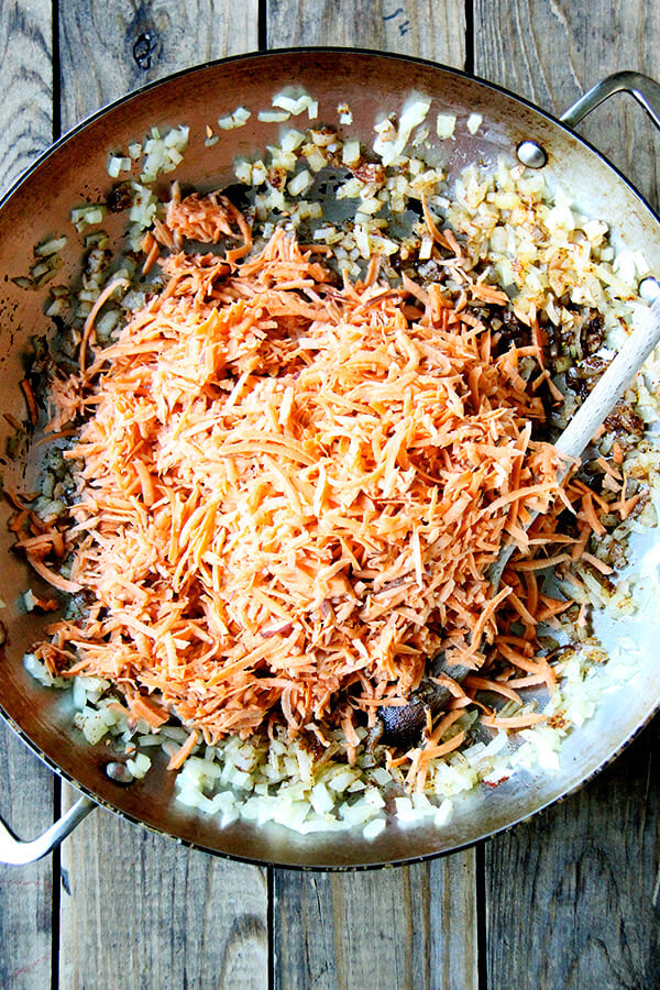 grated sweet potatoes added to onions, cumin, and chili powder