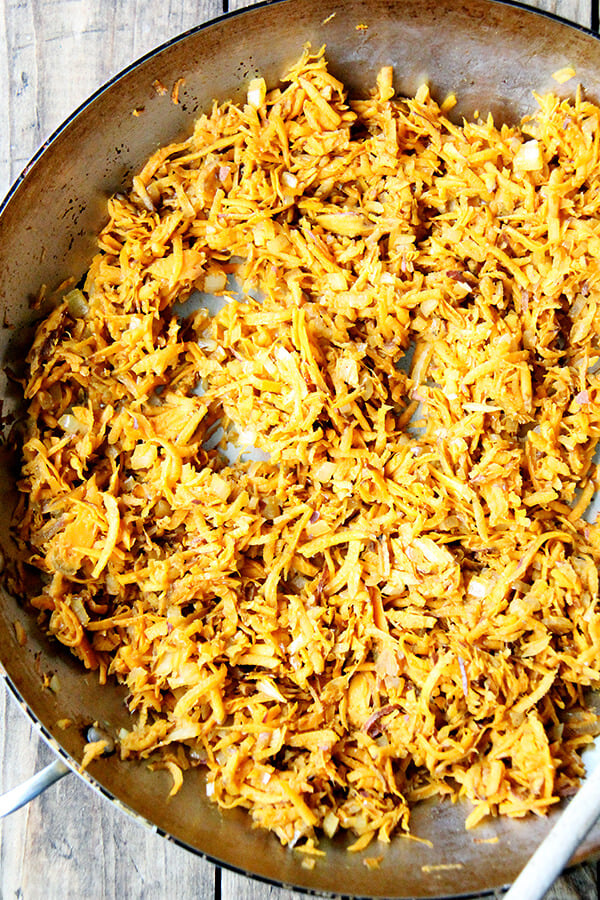 sauteed grated sweet potatoes in a sauté pan