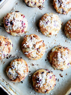An overhead shot of a tray of freshly baked cranberry snow scones.